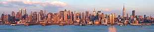 panoramic photography of metropolis under stratus clouds HD wallpaper