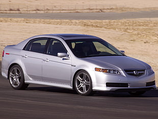 silver Acura TL on road at daytime