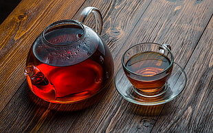 clear glass teapot with teacup and saucer set, tea