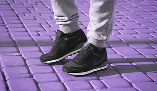 pair of black Nike running shoes