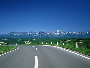road and mountain alps at distance during daytime HD wallpaper