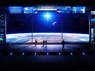 four people standing on stage with planet wallpaper