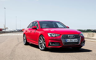 red Audi sedan on concrete road during daytime