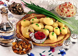 plate of potato and onion leaves with shot glasses