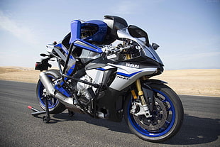 white, black, and blue Yamaha R1 sports bike
