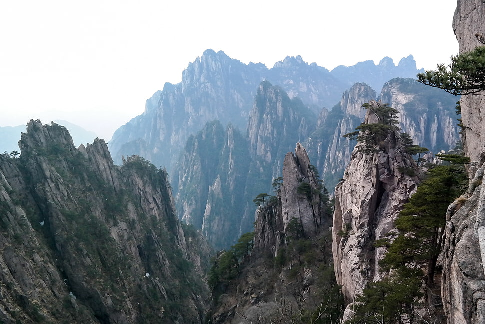 gray and green mountains under white cloudy sky during day time HD wallpaper