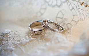 silver ring on white textile