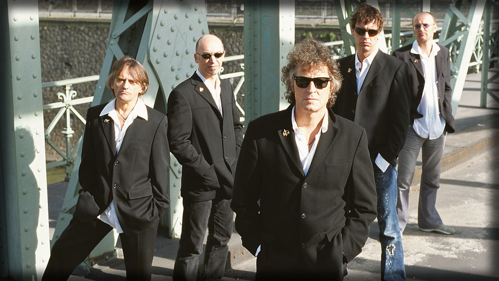 five men in black suit jacket standing on road HD wallpaper
