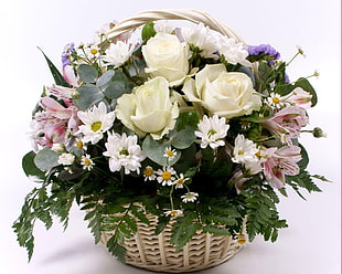 basket of white Roses, white Daisies, pink Peruvian Lilies, and purple Statice flowers