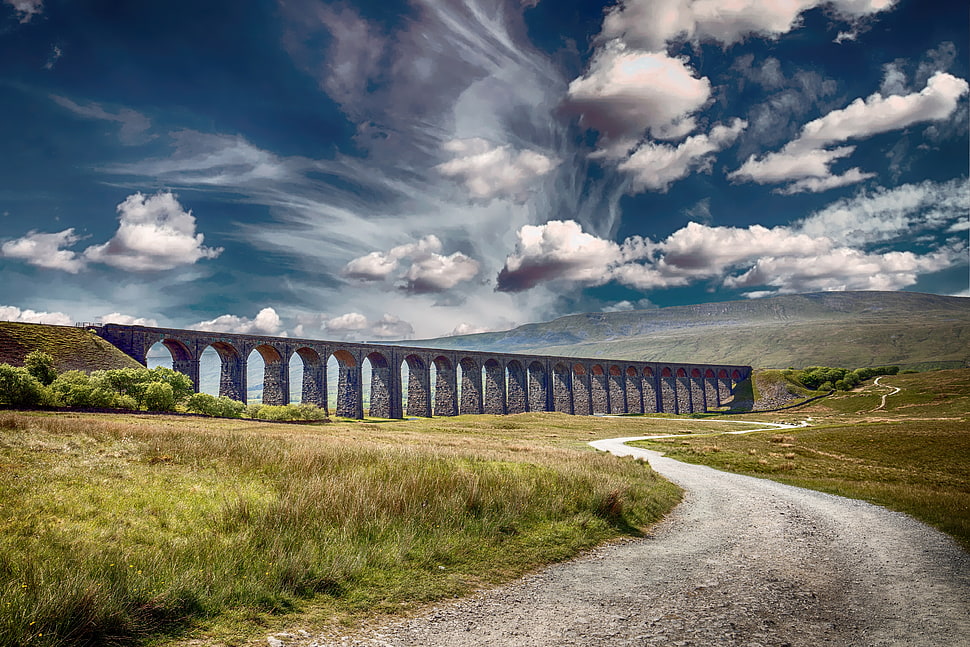 landscape photography of concrete bridge under cloudy sky during daytime HD wallpaper