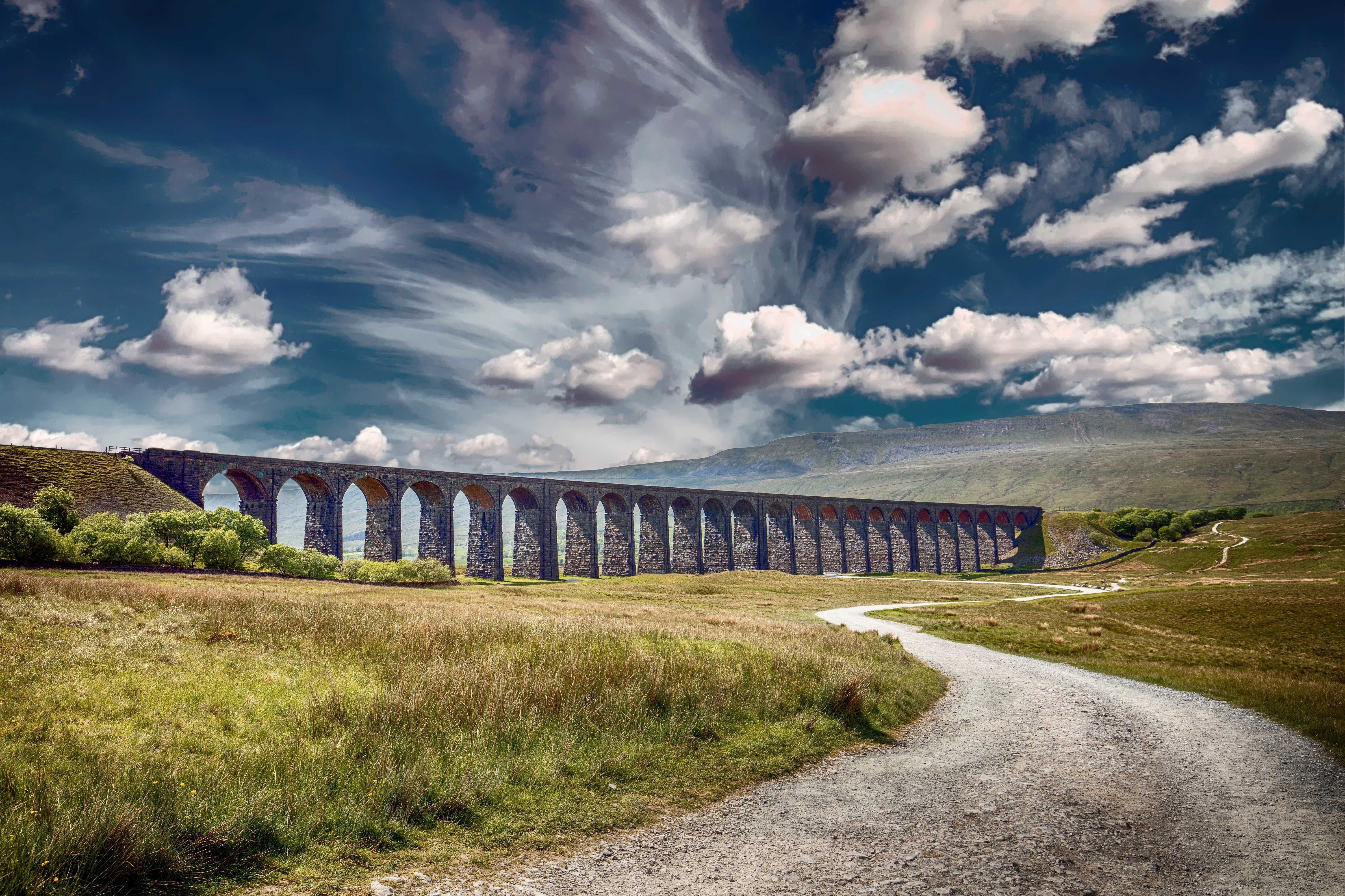 landscape photography of concrete bridge under cloudy sky during daytime