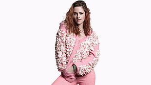 smiling woman wearing white and pink floral long-sleeved top