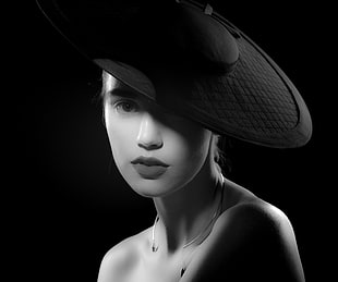 scale gray photography of woman wearing black hat
