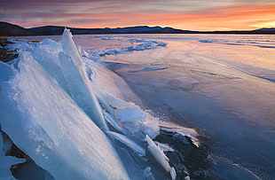 white ice berg during sunset