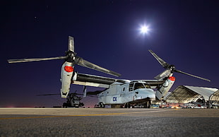 white military helicopter under clear night skies