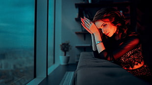 woman sitting on black sofa during nighttime