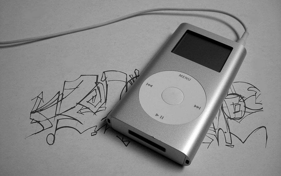 gray 1st Generation iPod Nano on white printed paper HD wallpaper