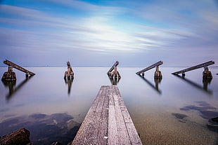 grey dock beside body of water at daytime, marken