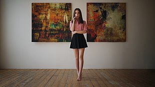 woman standing in between paintings