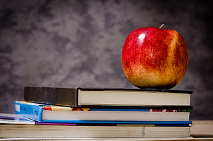 red Apple on top of two books