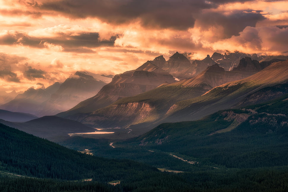 mountains with river under cloudy sky HD wallpaper