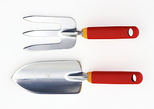 two red-and-gray gardening tools