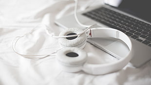 white and black plastic toy, headphones, MacBook