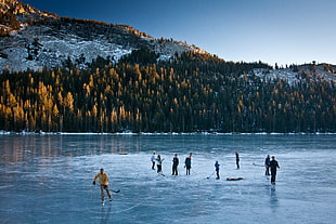 people ice skating on frozen lake HD wallpaper