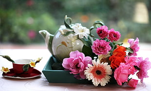 pink, white and orange flowers on table