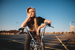 woman sitting on bike and resting face in right hand with close eyes HD wallpaper