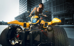 woman riding yellow ATV