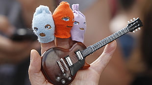 bokeh photo of person holding guitar mini figure