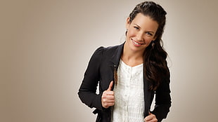woman wearing black blazer jacket while smiling