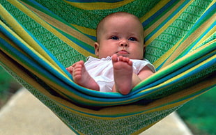 baby on green and yellow striped hammock HD wallpaper