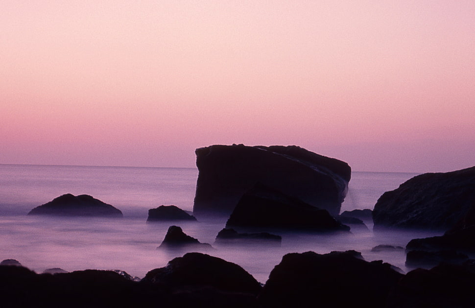 showing sea stack with mist HD wallpaper