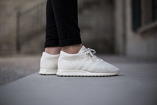 pair of white Adidas low-top sneakers