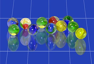 multicolored marbles on blue surface