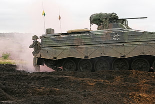 soldier beside tank during daytime