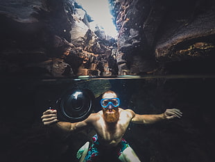 man underwater between rock formation, photographer, photography, underwater HD wallpaper