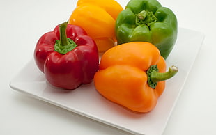 four bell peppers on plate
