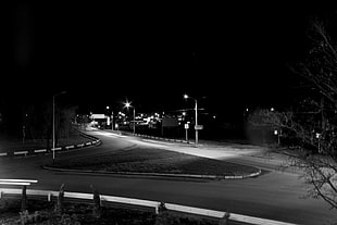 gray scale photo of empty road during nightime