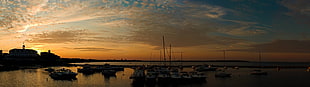 silhouette of building near body of water during golden hour HD wallpaper