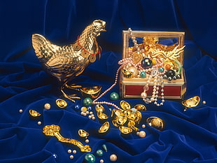 gold rooster figure on blue textile