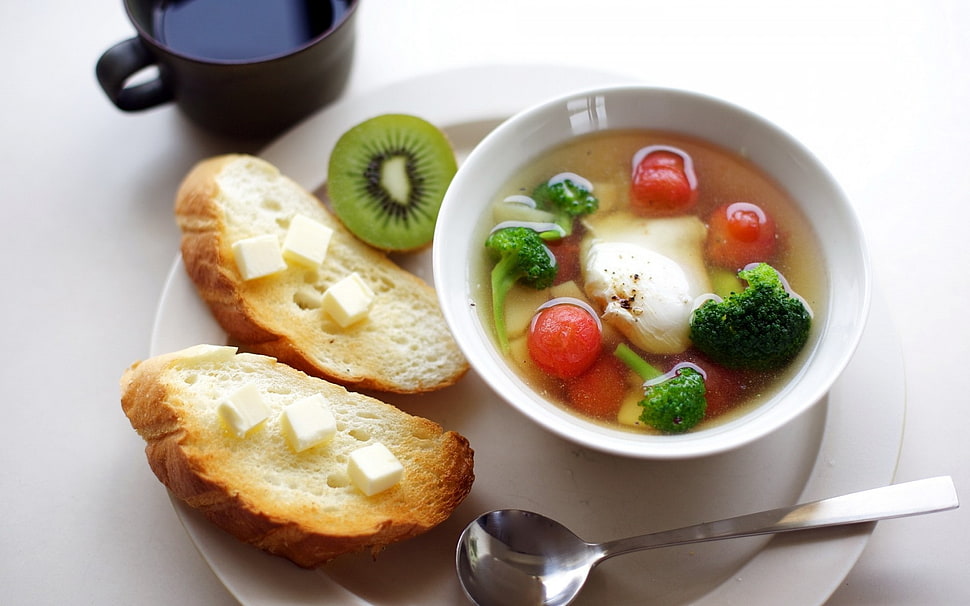 soup with small tomatoes and broccoli beside kiwi fruit and bread HD wallpaper