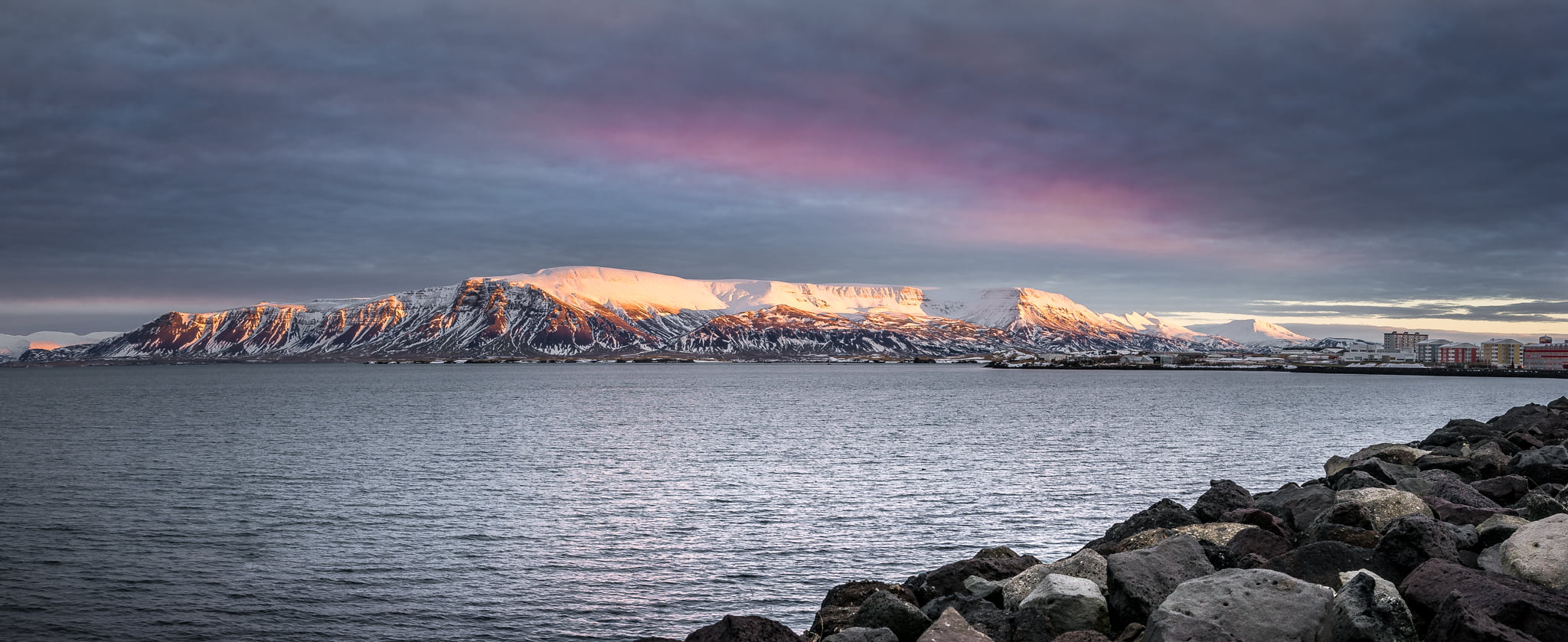 landscape photography of ocean near the mountain