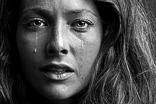 grayscale photo of woman crying