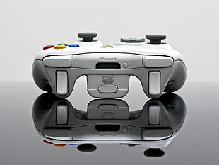 white Xbox 360 wireless controller on black surface