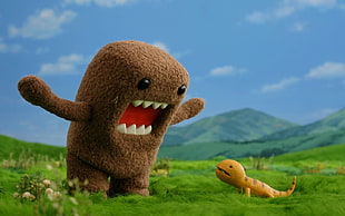 Domo   front of yellow Reptile on green grass field