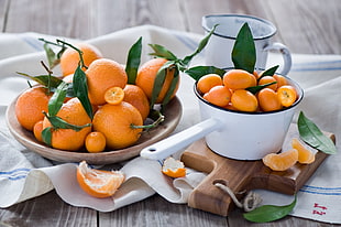 orange fruits on plate and dipper