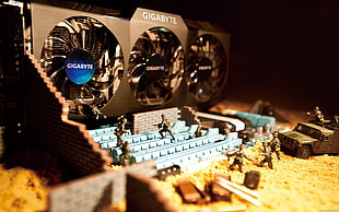 Gigabyte video graphic cards near army action figure lot HD wallpaper